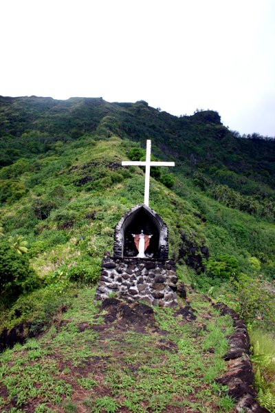 Cross and shrine set high on a hill side.